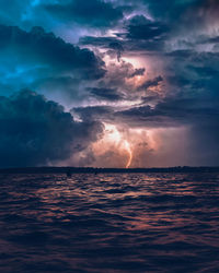 Scenic view of sea against storm clouds