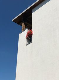 Low angle view of red building against blue sky