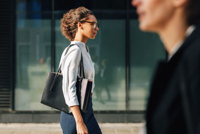 Side view of woman walking on street