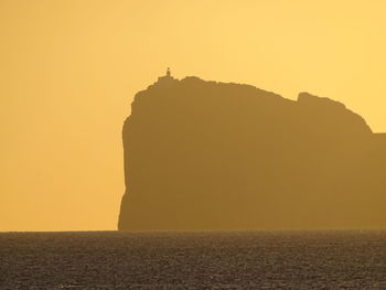 Scenic view of rock formation at sunset