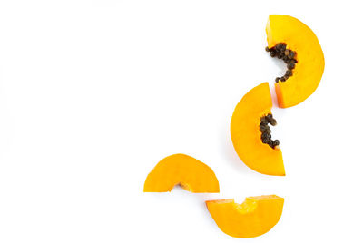 Close-up of orange fruit against white background