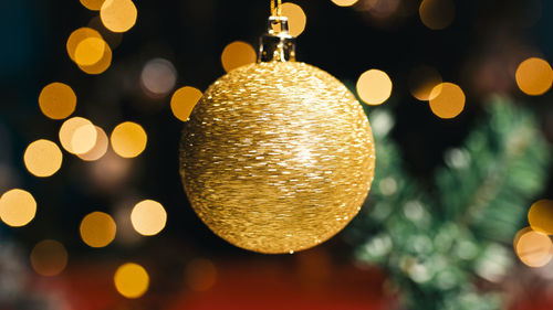 Christmas rotating golden color ball against the tree