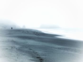 Scenic view of sea against sky during winter