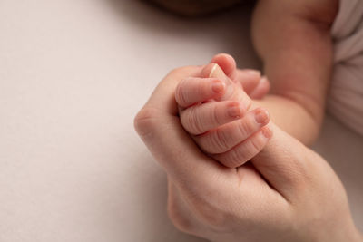 Woman holding baby's hand