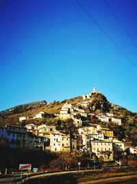 Residential district against clear blue sky