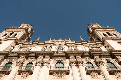 Low angle view of historical building against blue sky