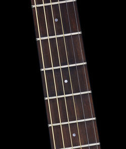 Close-up of guitar against black background