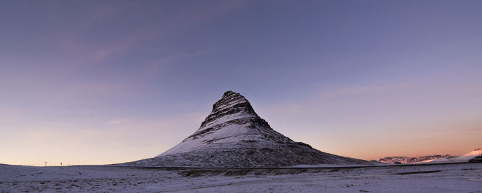 Scenic view of snowcapped mountain against sky during sunset