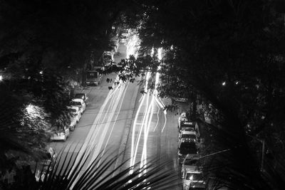 High angle view of road amidst trees at night
