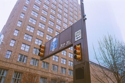 Low angle view of road sign against building