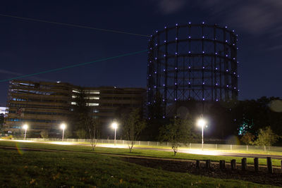 Illuminated city against sky at night