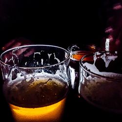 Close-up of beer glass against black background