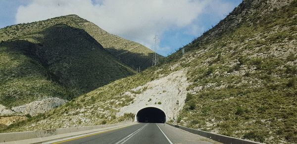 Road amidst mountains against sky