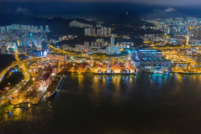 High angle view of illuminated buildings in city at night