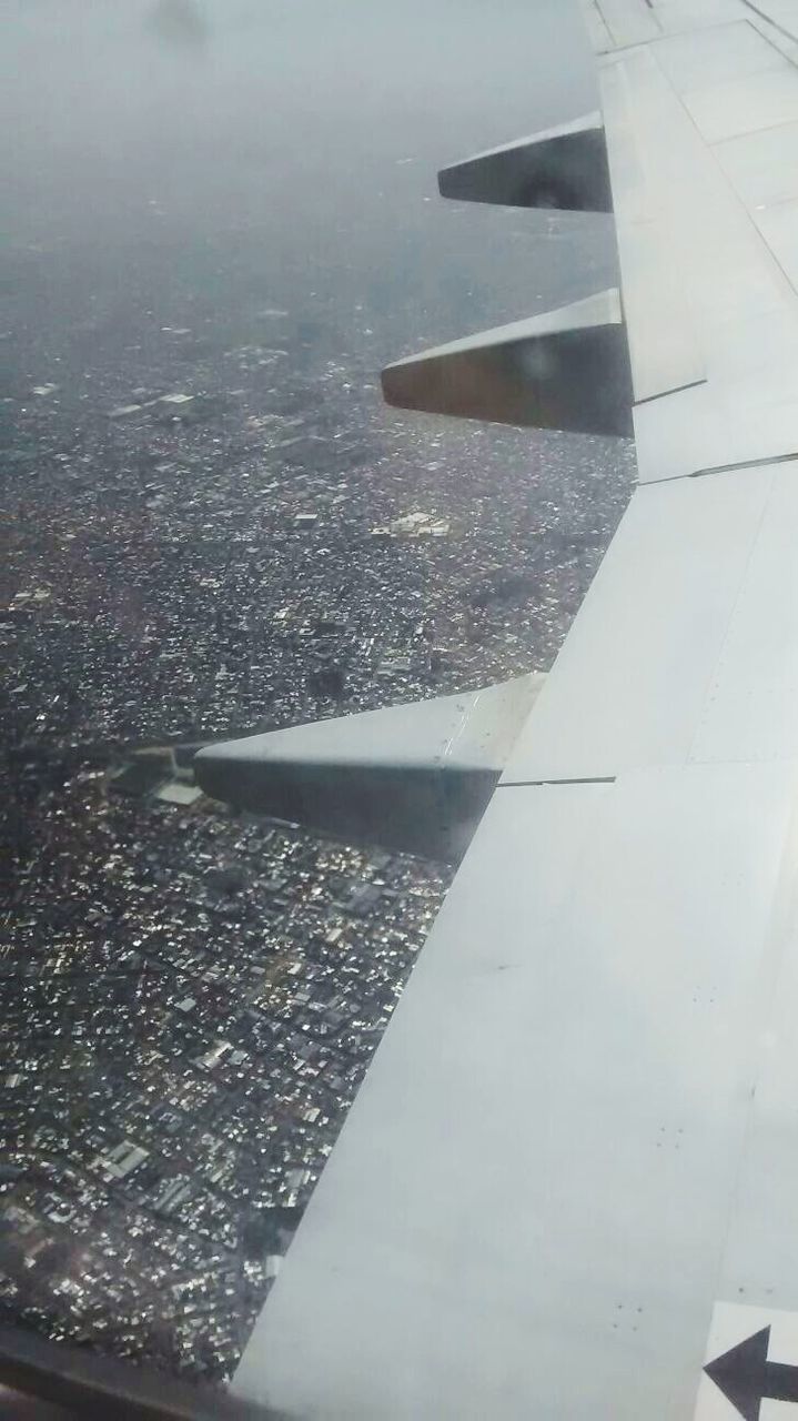 airplane, aircraft wing, flying, transportation, air vehicle, aerial view, part of, cropped, mode of transport, water, mid-air, travel, day, high angle view, no people, transparent, indoors, window, on the move, glass - material