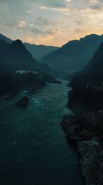 Scenic view of sea and mountains against sky