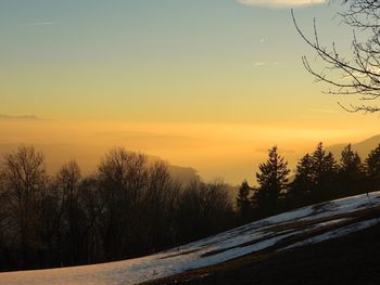 Scenic view of snowcapped mountains against sky during sunset