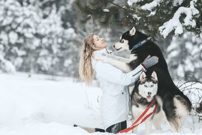 Woman with dog in snow