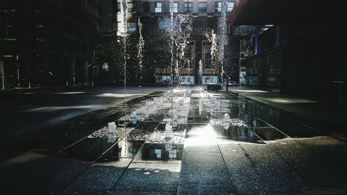 Fountain in city at night