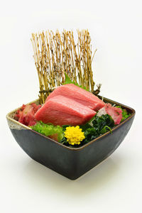 Close-up of vegetables in bowl against white background