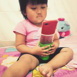 Cute baby girl sitting at home