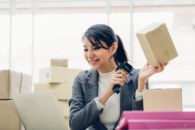 Portrait of young woman using mobile phone