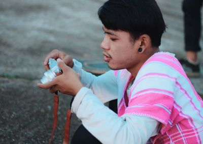 Side view of young man look to the camera 