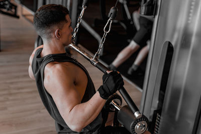 Side view of man exercising in gym