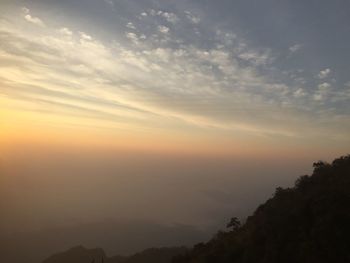 Scenic view of silhouette mountains against sky at sunset