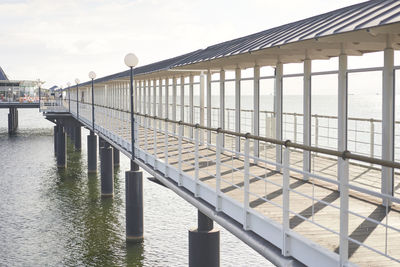 Pier over river against sky