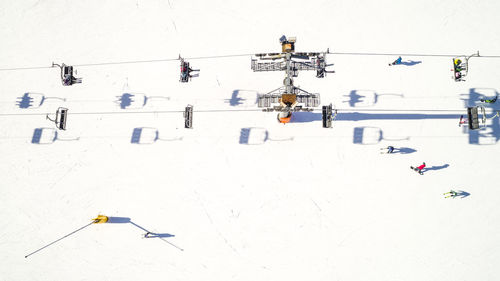 High angle view of ski lift on snow covered land