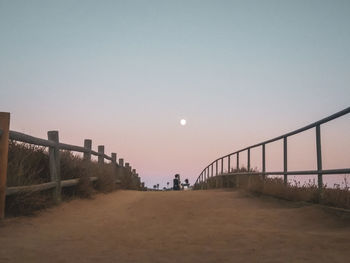 Scenic view of bridge against clear sky at dusk