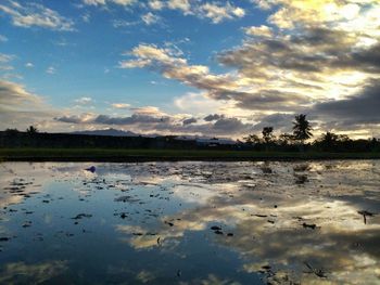 Scenic view of lake against sky during sunset