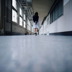 Surface level of woman standing in corridor
