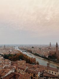 High angle view of townscape by sea against sky