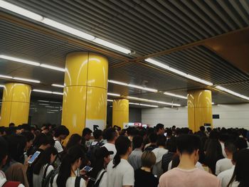 Group of people waiting on railway station platform