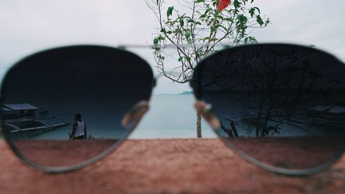 Close-up of basketball by sea against sky
