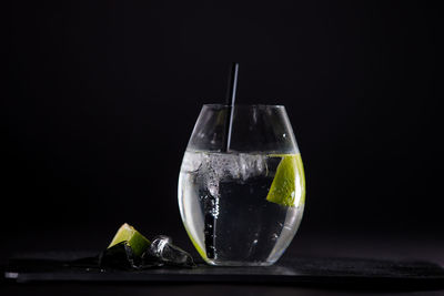Close-up of drink in glass on table against black background