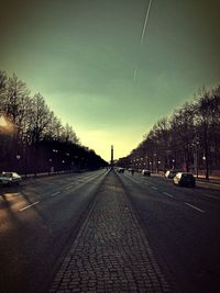 Empty road along trees