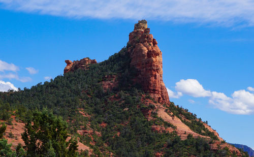 Low angle view of rock formation against sky