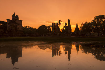 Reflection of building in lake at sunset