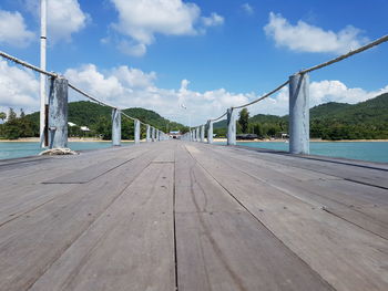 Surface level of footbridge against sky