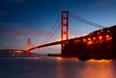 Low angle view of suspension bridge at night