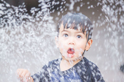 Portrait of boy playing in lake