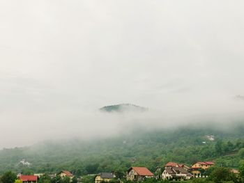 Houses on mountain against sky