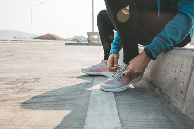 Low section of man sitting on street