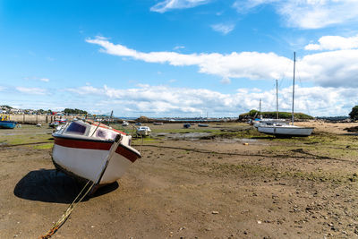 Sailboats moored on beach