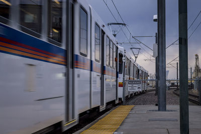 Train at railroad station against sky