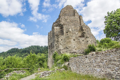 Old ruins of building against cloudy sky