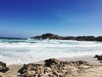 Scenic view of sea against clear blue sky